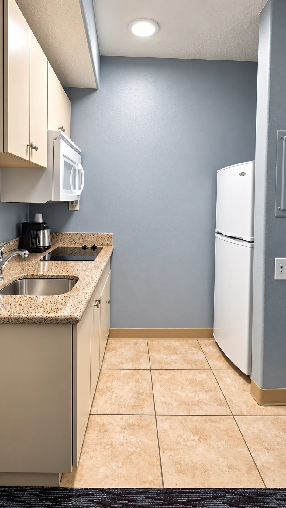 Kitchenette with two-burner cooktop, sink, microwave, coffee maker and full-height refrigerator — Best Western Vernal Inn, Vernal Utah