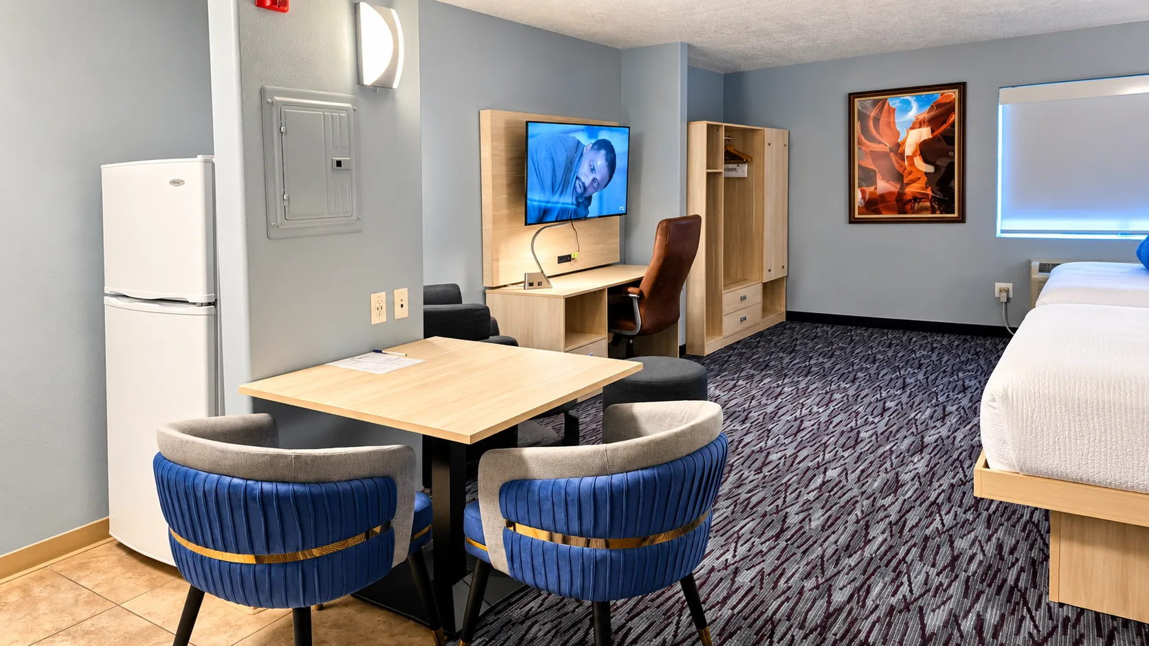 Dining table and full-height refrigerator in a studio room — Best Western Vernal Inn, Vernal Utah