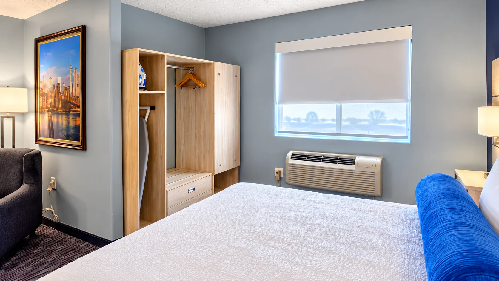 Open closet with hangers, iron and ironing board next to a window in a Studio Two Queen — Best Western Vernal Inn, Vernal Utah