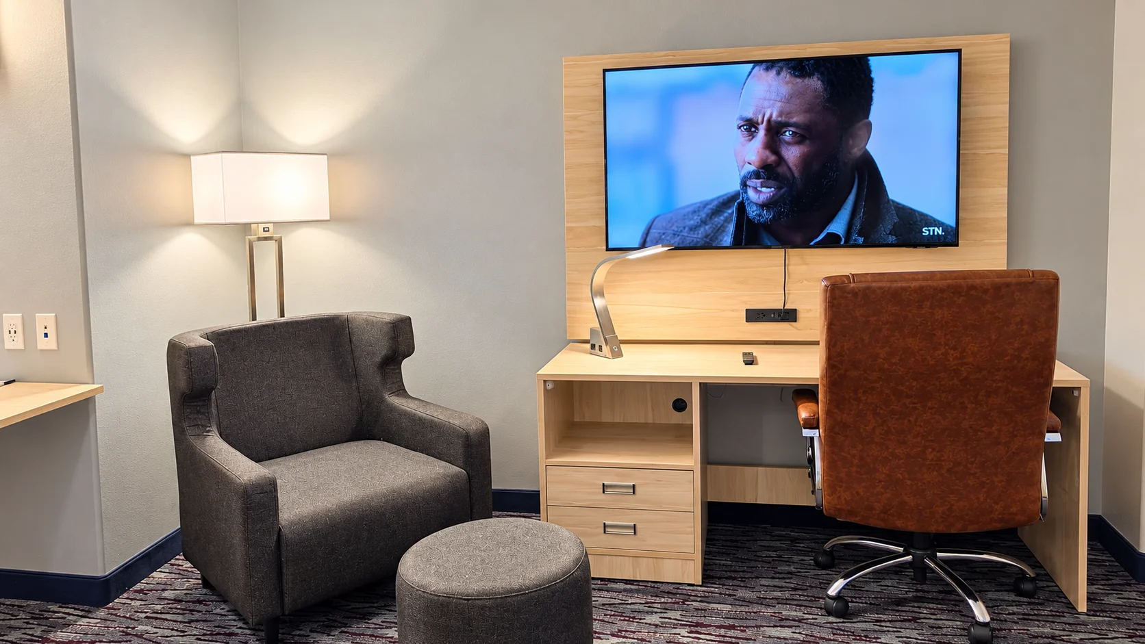 Armchair, ottoman, floor lamp and wall-mounted TV in a guest room — Best Western Vernal Inn, Vernal Utah