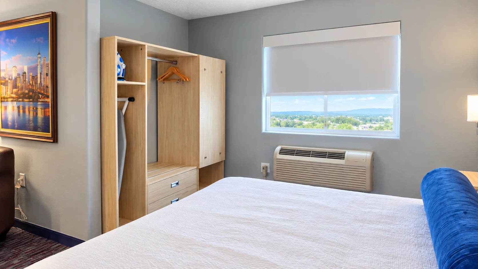 Open closet with hangers, iron and ironing board beside a window — Best Western Vernal Inn, Vernal Utah
