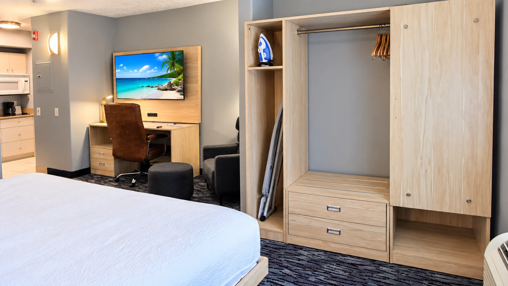 Kitchenette, desk, TV, armchair and open closet in an accessible studio — Best Western Vernal Inn, Vernal Utah