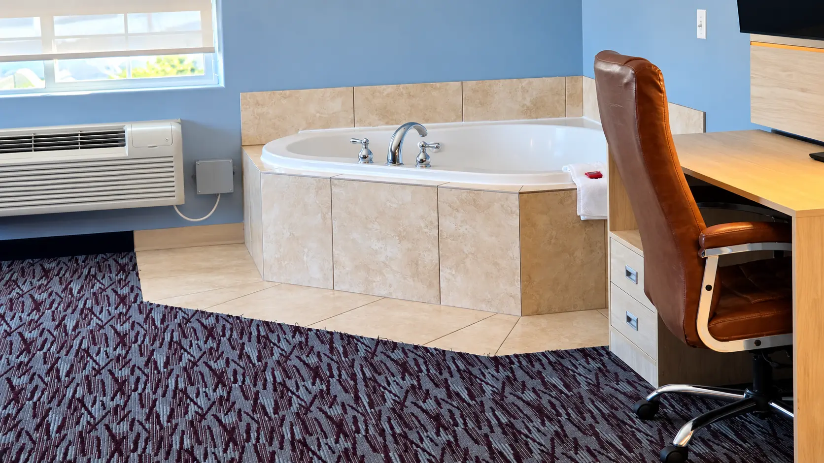 Corner jacuzzi tub with chrome fixtures and a tiled surround — Best Western Vernal Inn, Vernal Utah