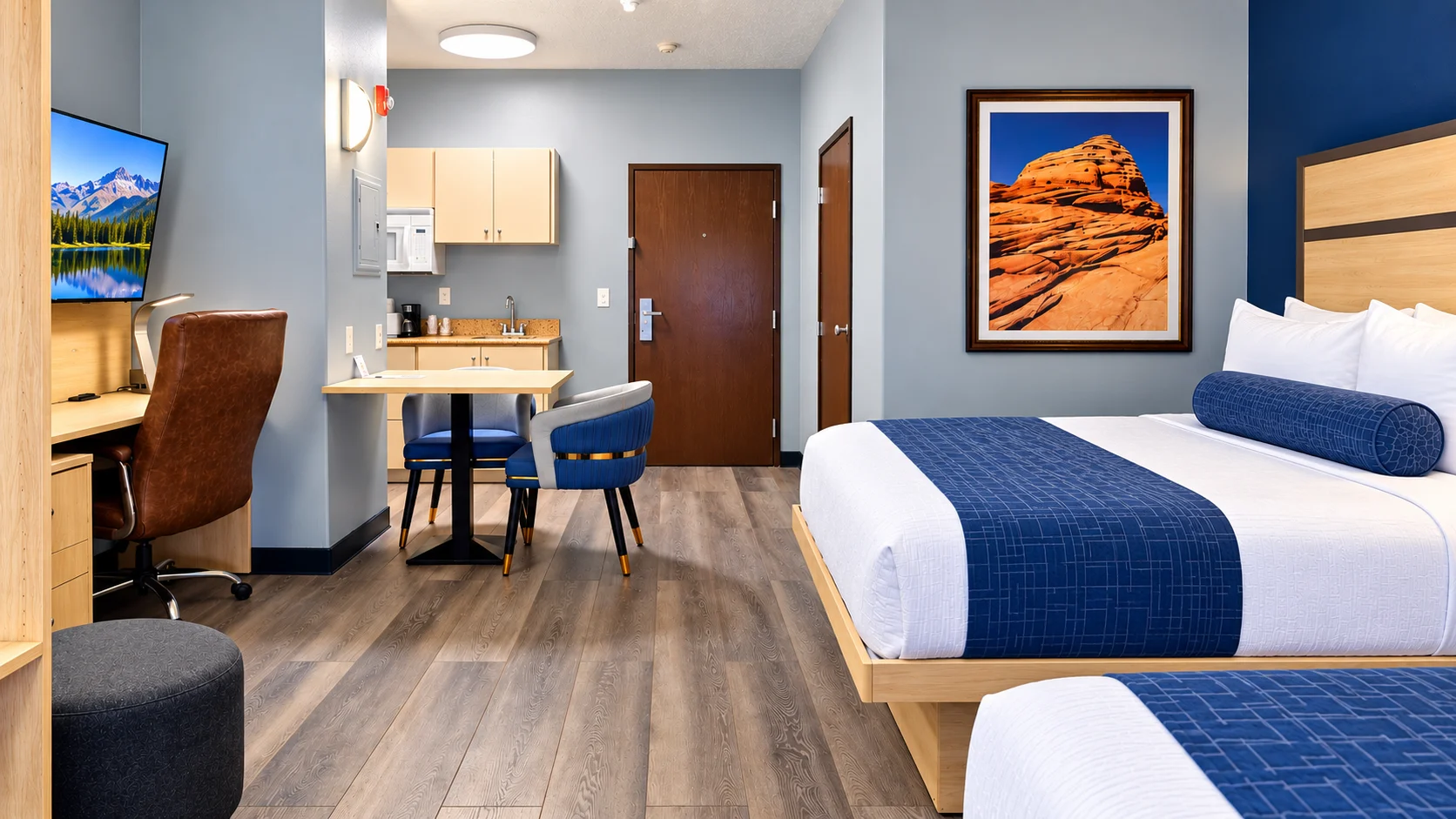 Full view of a pet-friendly studio showing entrance, kitchenette, dining table and wood-style floors — Best Western Vernal Inn, Vernal Utah