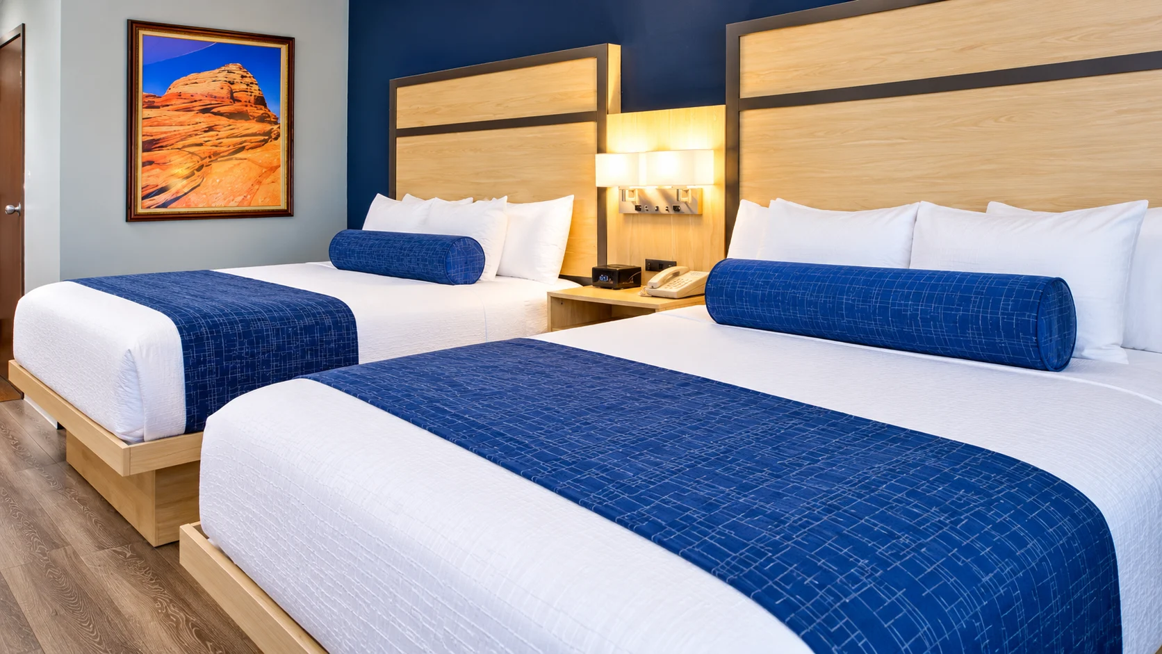 Two queen beds sharing a nightstand and wall light — Best Western Vernal Inn, Vernal Utah