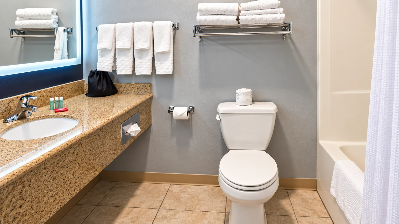 Guest bathroom with granite vanity, backlit mirror, toilet and tub — Best Western Vernal Inn, Vernal Utah