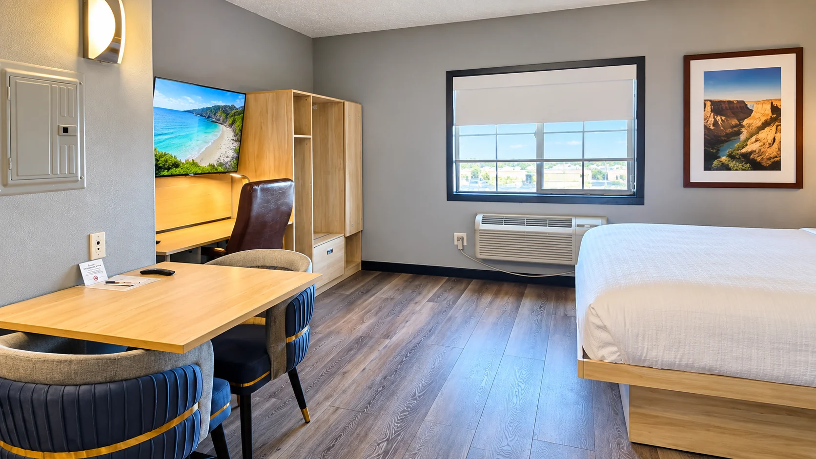 Pet-friendly king room showing desk, TV, dining table, window and bed — Best Western Vernal Inn, Vernal Utah
