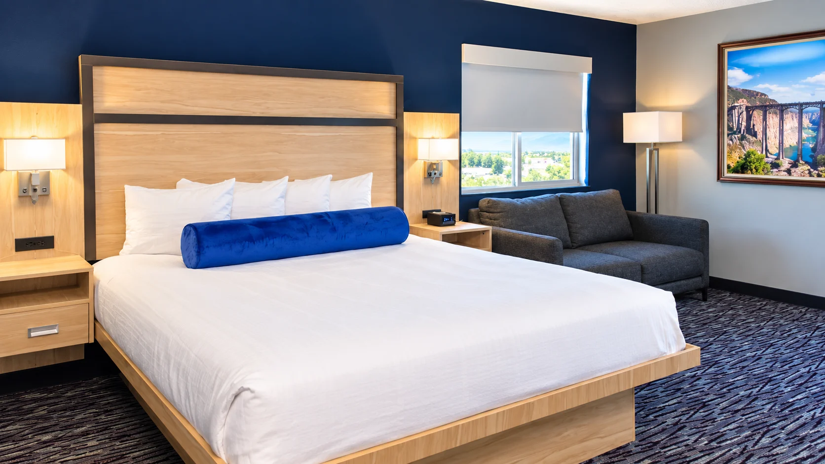 Queen bed with a two-seat sofa under the window — Best Western Vernal Inn, Vernal Utah