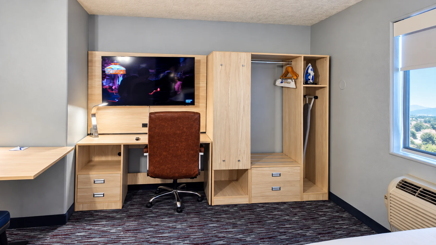 Desk, office chair, wall-mounted TV and open closet beside a window — Best Western Vernal Inn, Vernal Utah